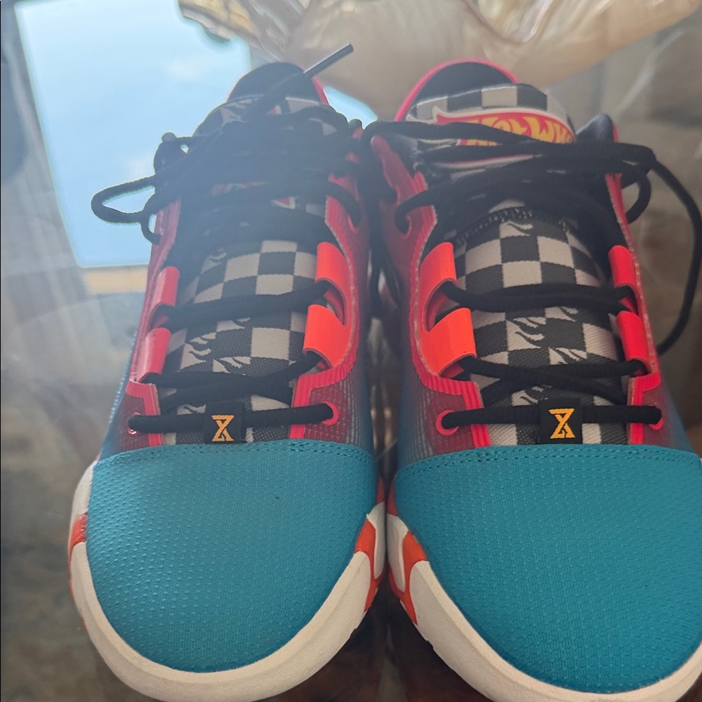 Nike PG 6 x Hot Wheels collaboration sneakers in a blue, orange, and red